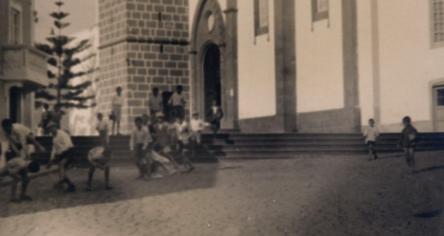 Detalle de la imagen antigua de niños y niñas jugando cerca de la iglesia de Santa Brígida